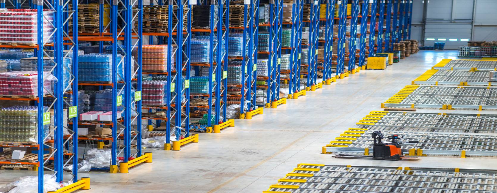 Distribution warehouse building interior and large storage area with goods on the shelf.