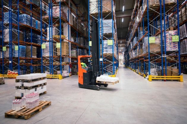 Industrial building large warehouse interior with forklift and palette with goods and shelves. racking system manufacturer